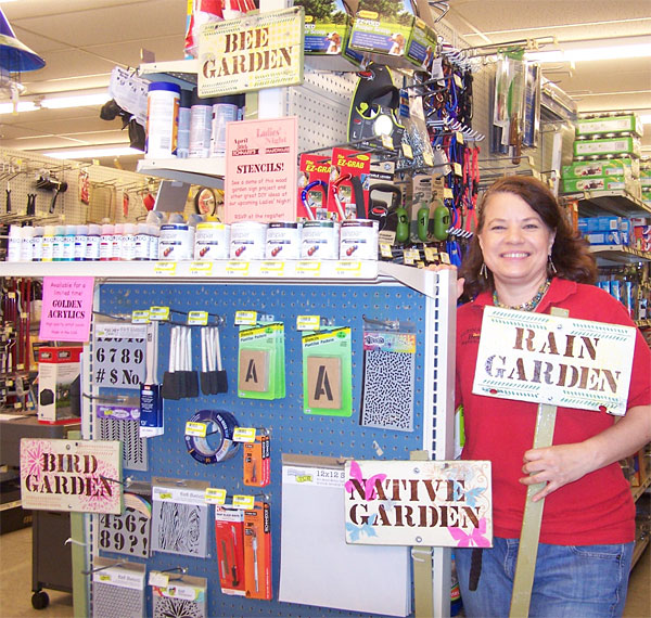 Schnarr's employee Carolyn with several finished signs and a selection of supplies you can use to make one. Carolyn will be demonstrating stenciling at our Ladies' Night on April 30, 2015.
