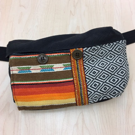 Fabric pouch refurbished by repairing the zipper and adding a front pocket made from salvaged materials.