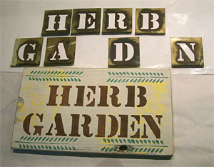 Finished wood garden sign with stencils.