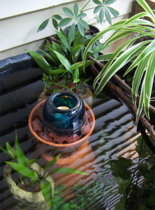 Small outdoor water garden with flameless candle