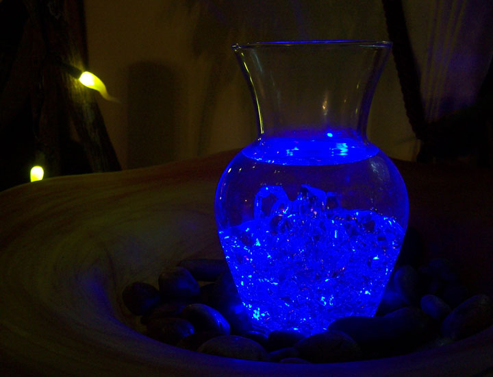 Color changing water light displayed indoors on a stand.