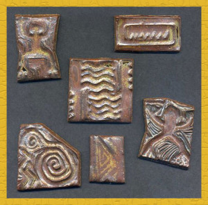 Handmade stoneware tiles impressed with carved rubber stamps. These will be installed in tile murals in my kitchen.